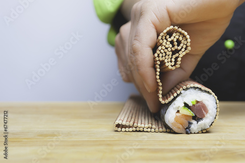 rolling up sushi photo