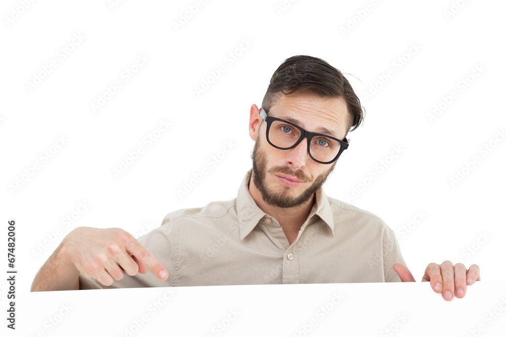 Geeky hipster pointing at poster Geeky hipster pointing at poster