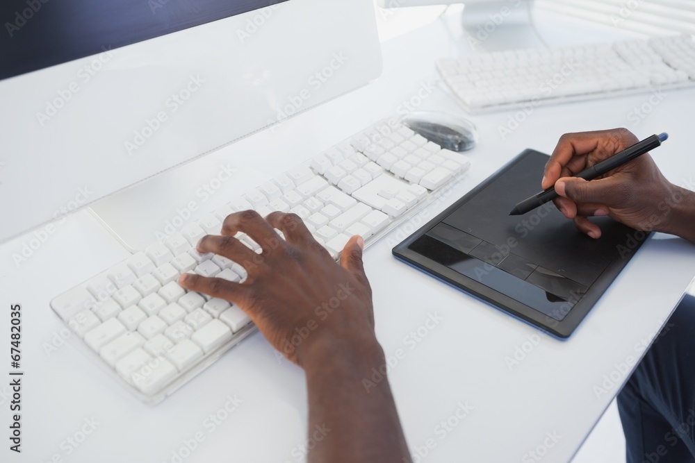 Designer sitting at his desk working with digitizer Designer sitting at his desk working with digitizer