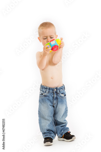 Young half naked boy is taking a photo with his toy camera