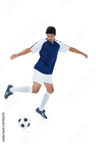 Football player in blue kicking ball © WavebreakmediaMicro