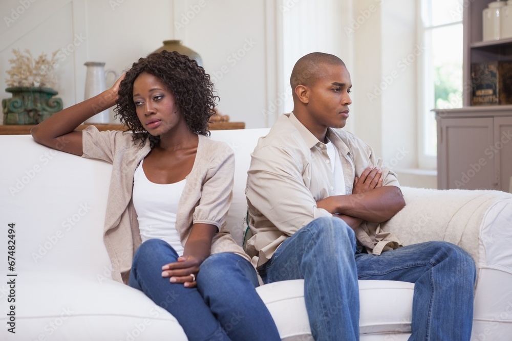 Unhappy couple not speaking to each other on sofa Unhappy couple not speaking to each other on sofa