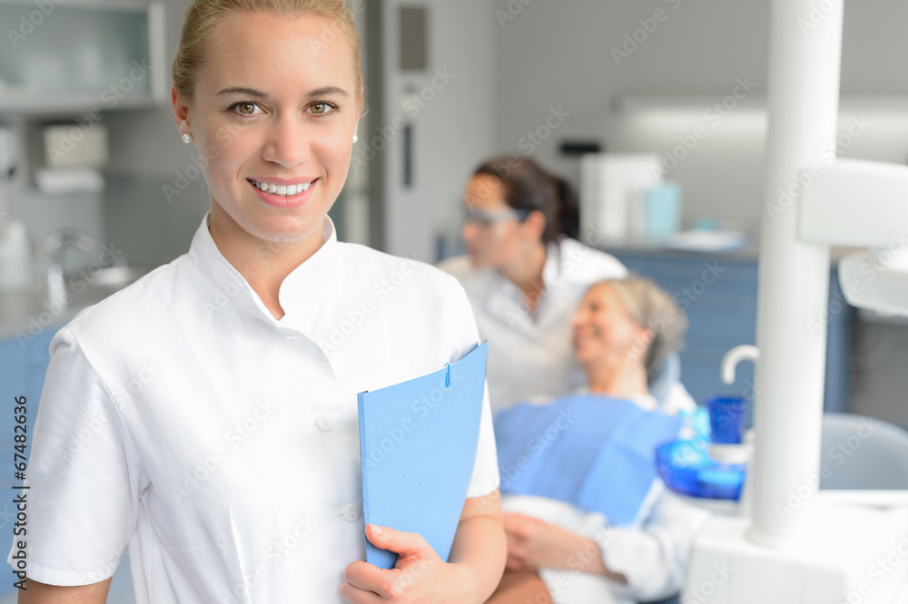 Dental assistant smiling dentist with patient Dental assistant smiling dentist with patient