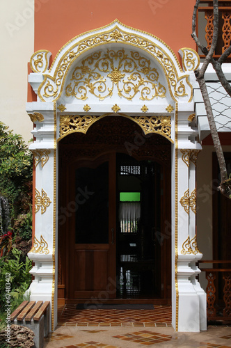 White and gold frame of hotel entrance.