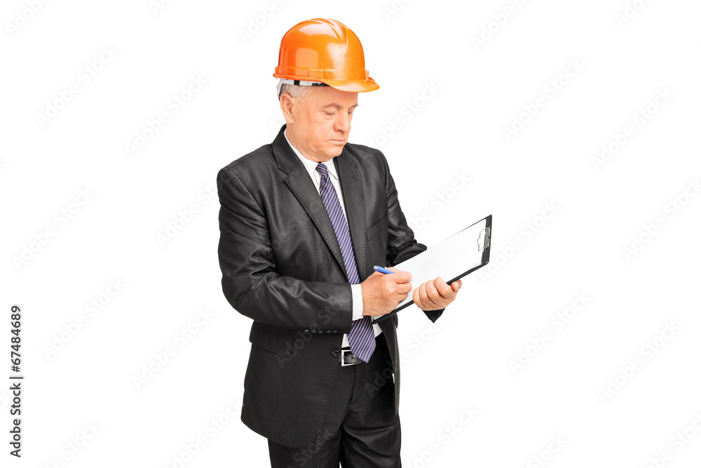 Construction worker taking notes on a clipboard Construction worker taking notes on a clipboard