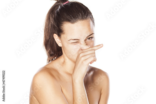 young girl rubs her nose photo