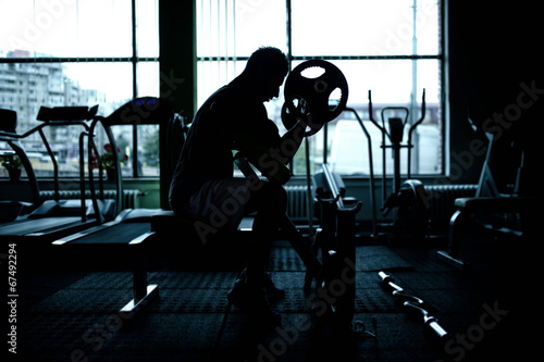 silhouette of an athletic man working out at gym