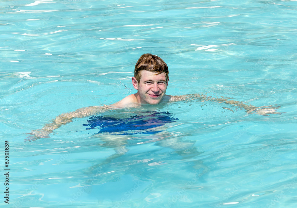 boy has fun swimming in the pool