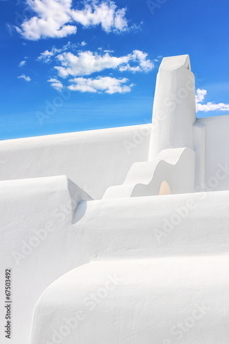 Stylish white chimney against blue sky in Mykonos.NEF
