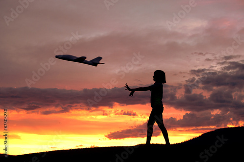 Girl flies a toy plane.