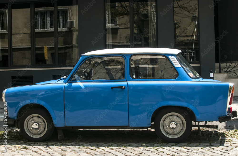 Blue vintage restored Trabant car on paved street