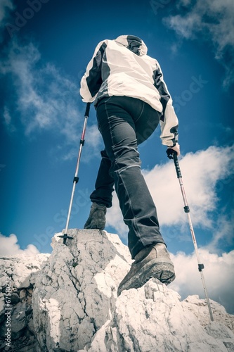 Young woman ascending a mountain ridge
