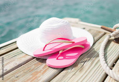 close up of hat and slippers at seaside