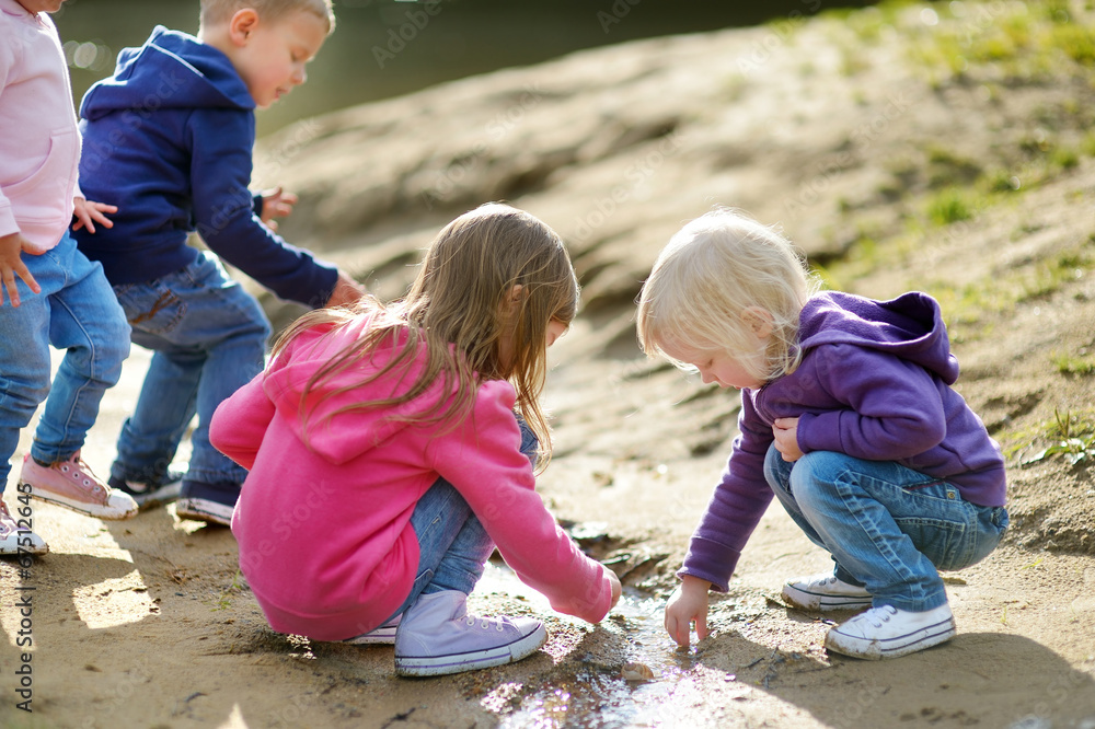 Four happy kids playing by a river Four happy kids playing by a river