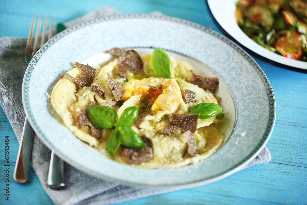 Ravioli pasta filled with ricotta, egg yolk and black truffles Ravioli pasta filled with ricotta, egg yolk and black truffles