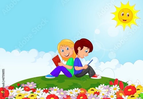 Boy and girl reading book in the flower garden