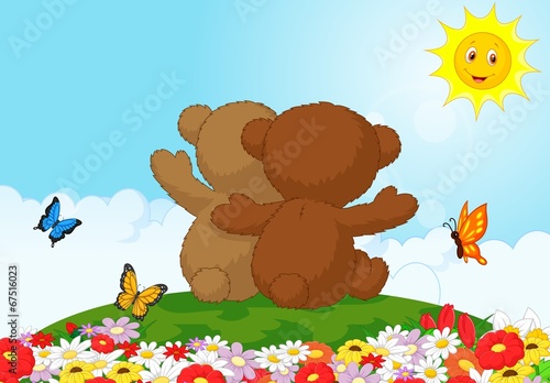 Back view of two teddy bears sitting in the garden