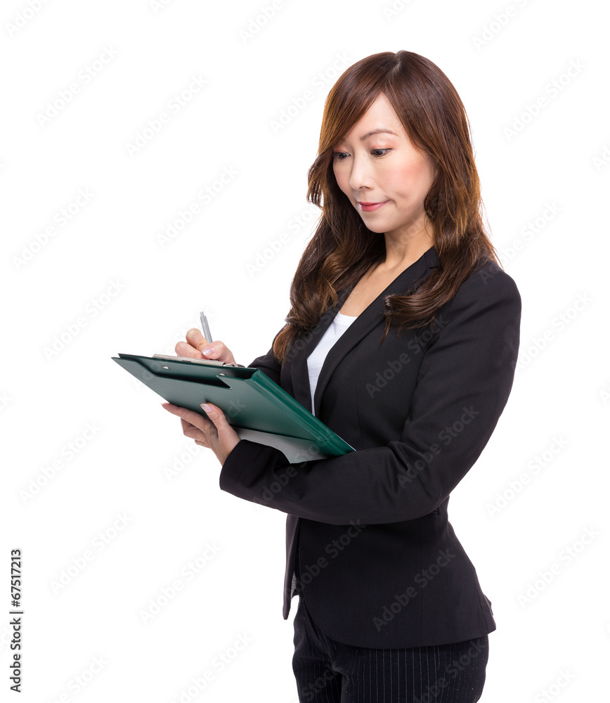Asian businesswoman write on clipboard Asian businesswoman write on clipboard