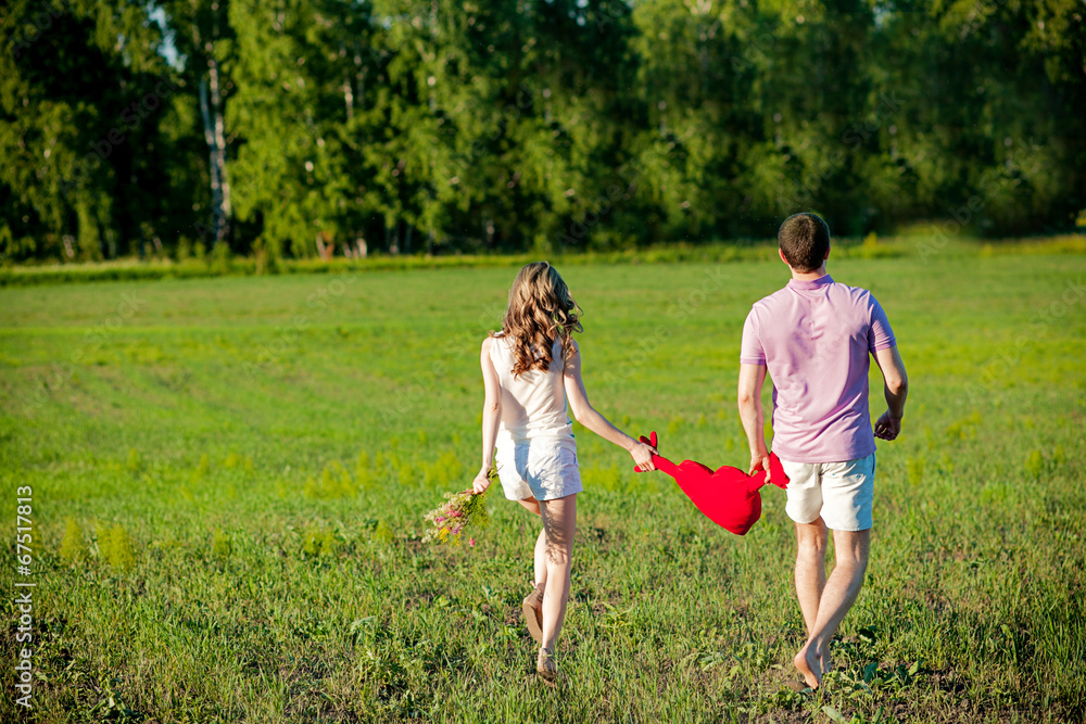 Fototapeta premium loving couple runs across the field