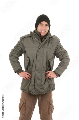 latin young man wearing green winter coat and a beanie
