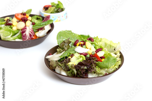 Plate with salad on white table