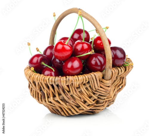 fresh cherries in a wicker basket isolated on white background
