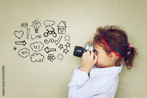 Concept of cute kid looking through vintage camera viewfinder an