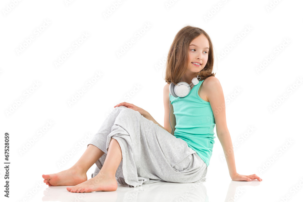 Girl sitting with headphones on her neck Girl sitting with headphones on her neck