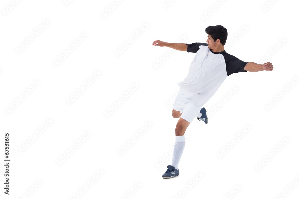 Football player in white kicking Football player in white kicking