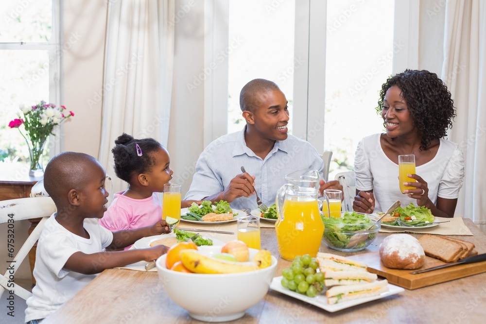Happy family enjoying a healthy meal together Happy family enjoying a healthy meal together