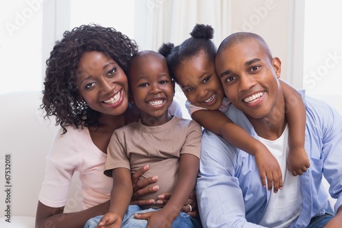 Happy family posing on the couch together