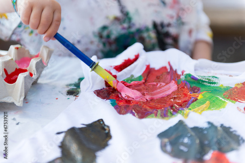 Child Painting On Cloth