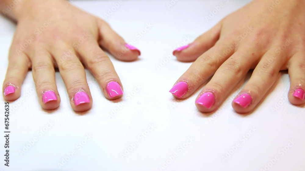 Hands showing fresh pink manicure Hands showing fresh pink manicure