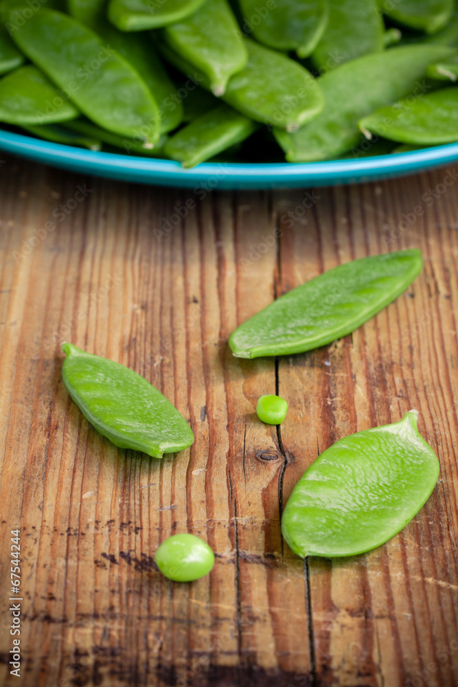 pods of green peas on a wooden background pods of green peas on a wooden background