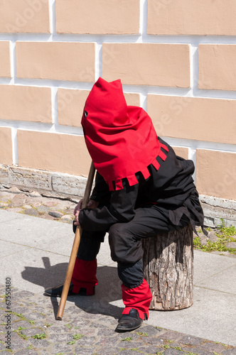 executioner sitting near the wall on the street photo