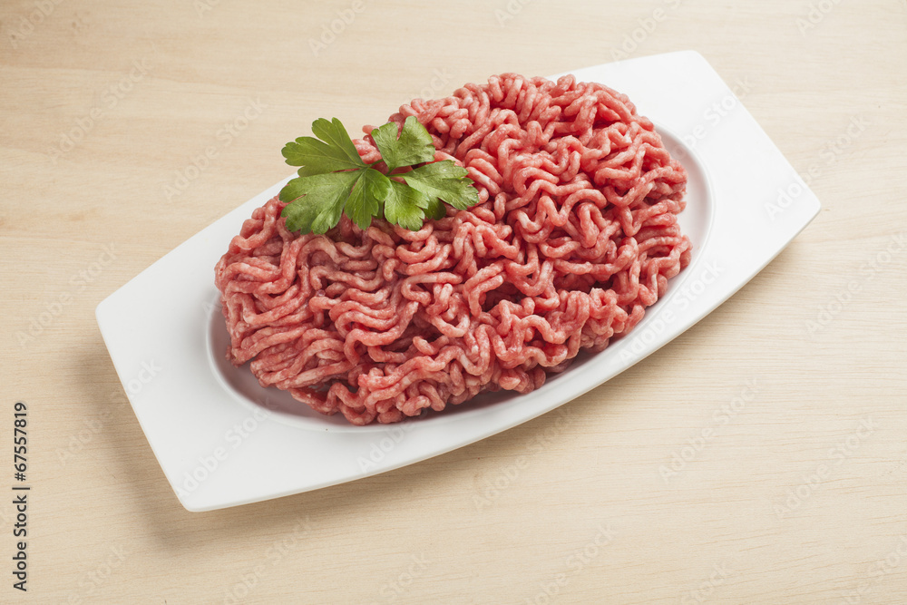 Minced meat over wooden background Minced meat over wooden background