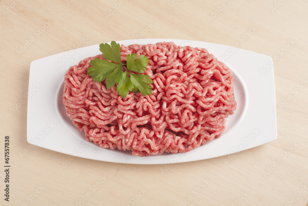 Minced meat over wooden background Minced meat over wooden background