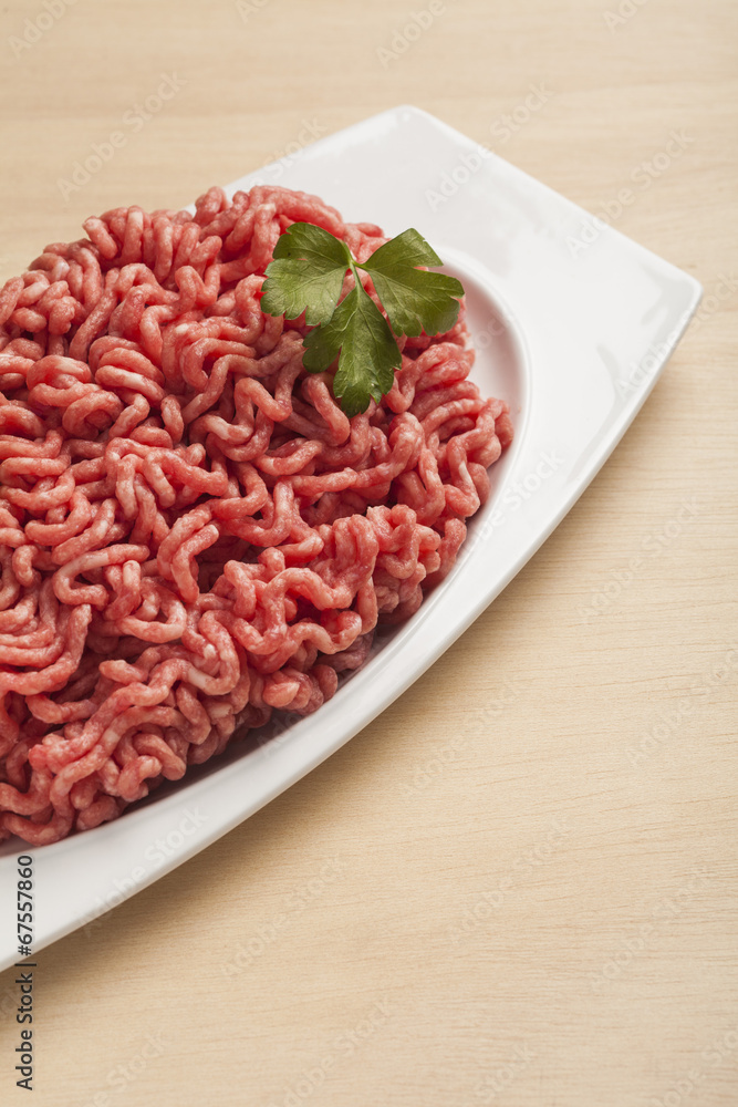 Minced meat over wooden background