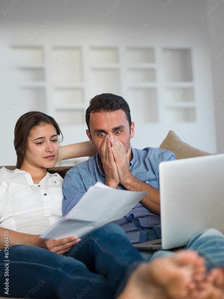 relaxed young couple working on laptop computer at home relaxed young couple working on laptop computer at home