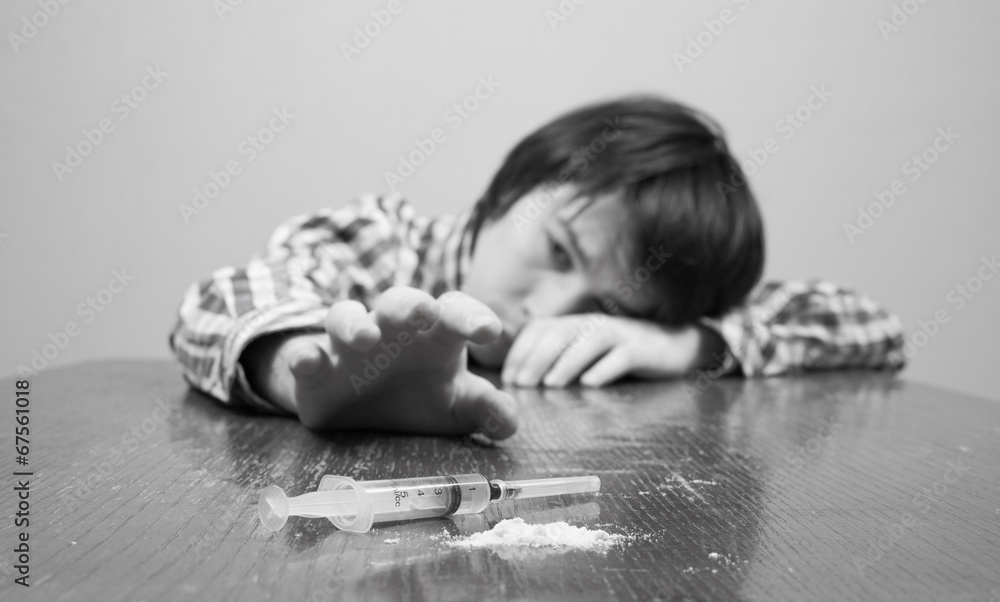 young man raises his hand to drugs