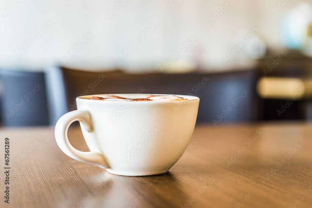 Fototapeta premium Coffee cup in coffee shop interior
