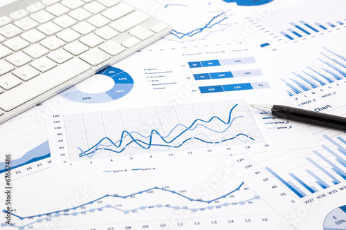 blue graph and chart reports on office table