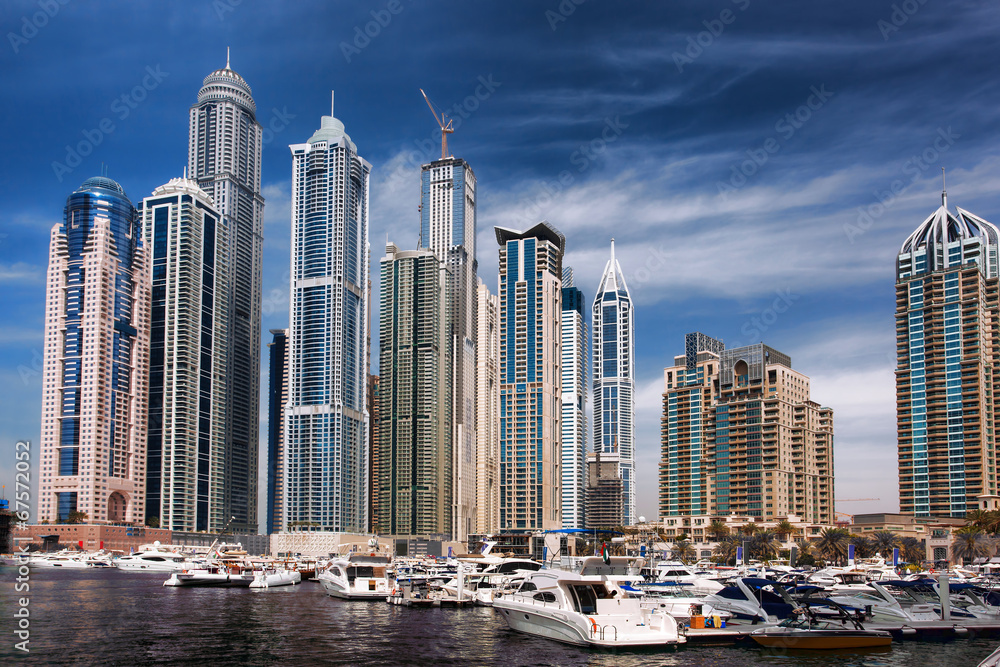 Fototapeta premium Dubai Marina with boat against skyscrapers in Dubai, UAE