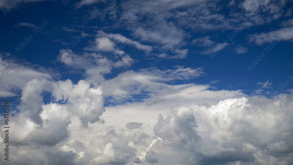 White clouds running over blue sky. Timelapse