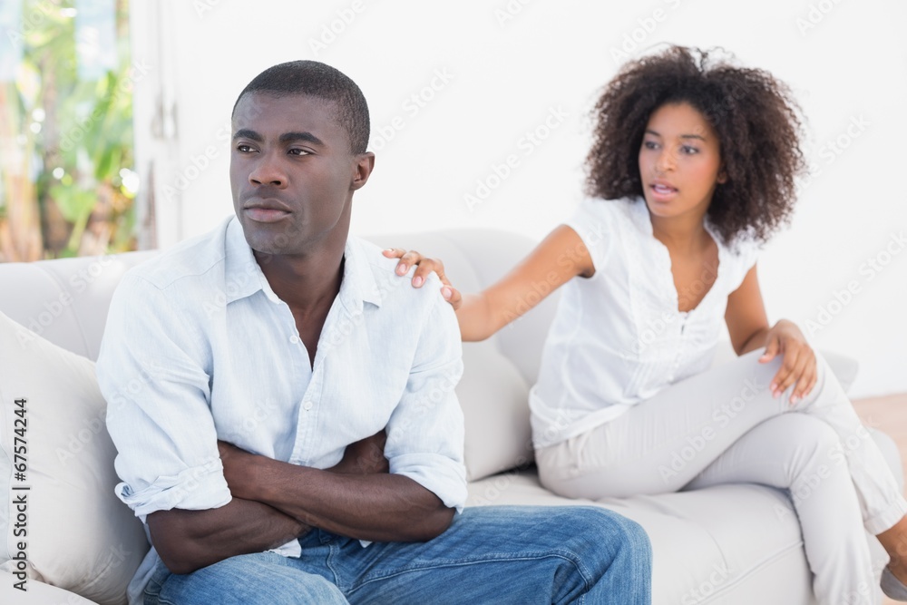 Attractive couple having an argument on couch Attractive couple having an argument on couch