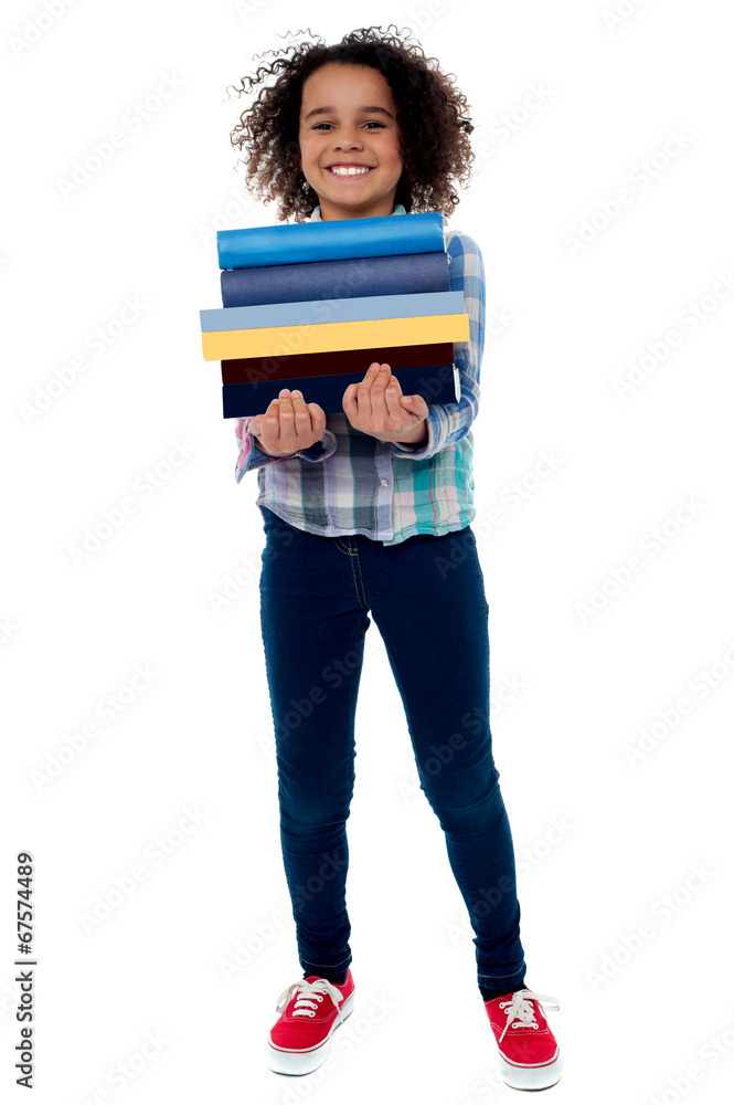 Cute little girl carrying stack of books Cute little girl carrying stack of books