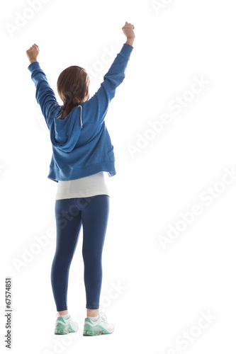 Rear view of young woman stretching her hands