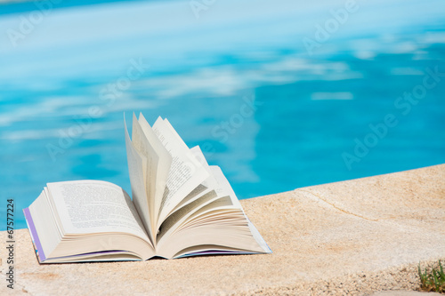 Leisure at the swimming pool with book