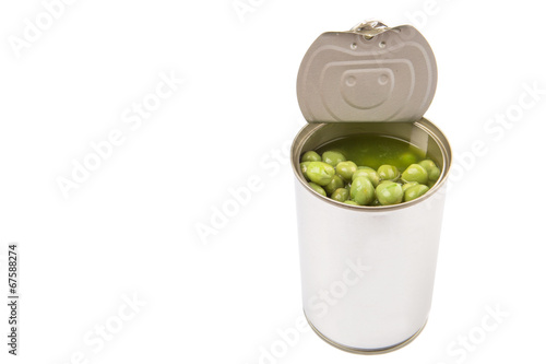 Green peas in a tin can over white background 