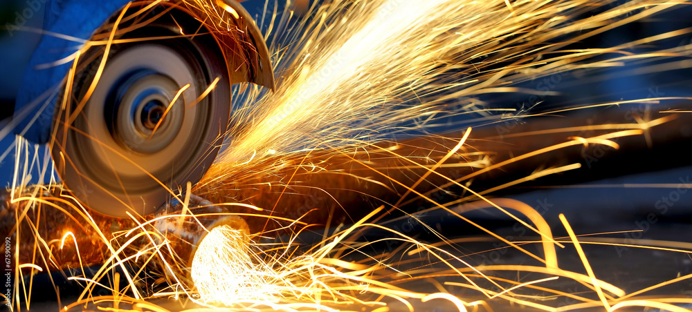 Photography Worker cutting metal with grinder